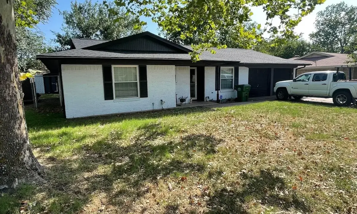 Professional roofing crew working on a residential roof in Excelsior Springs